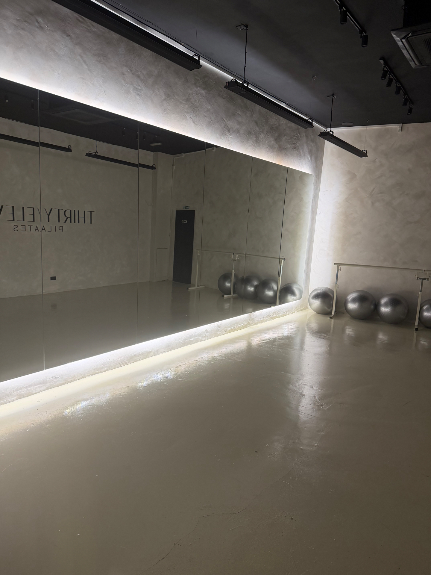 Mat and barre studio with mirrored wall